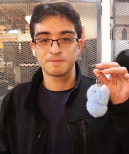 Ivan Trejo holding up a small item
